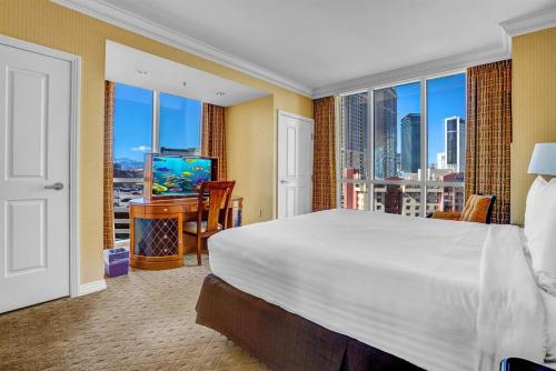 a bedroom with a large bed and a large window at MGM 1BR Suite 7th Floor Strip View, Balcony in Las Vegas