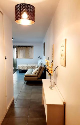 a living room with a couch and a table at F2 Cookoon Toata Papeete in Papeete