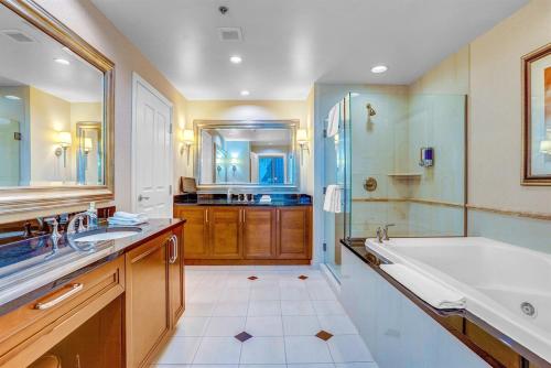 a bathroom with a tub and a sink and a shower at MGM 1BR Suite 7th Floor Strip View, Balcony in Las Vegas
