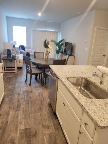 a kitchen and living room with a table and a couch at Coastal Charm 3-bedroom townhome in Myrtle Beach