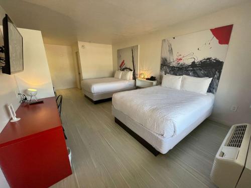 a hotel room with two beds and a desk at Cozy hotel with Super location near Disney in Kissimmee