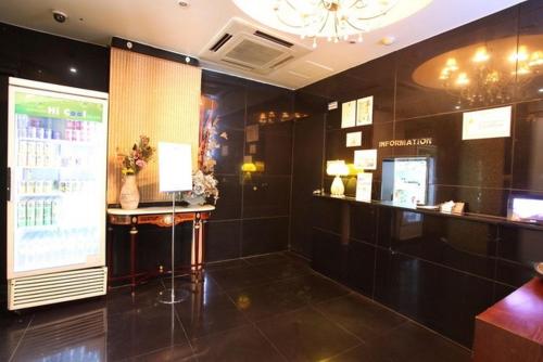 a room with black tiled walls and a bar at Yeoksam Molta 1 in Seoul