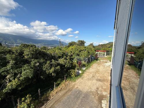 a view from a train window of a dirt road at Apartamento campestre 202 in Ibagué