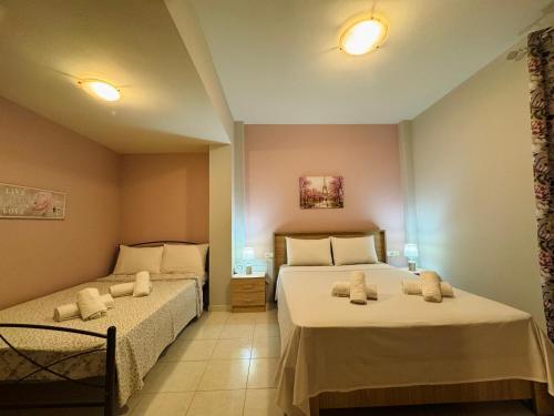 a bedroom with two beds with towels on them at Philoxenia Guest House in Makrirrákhi
