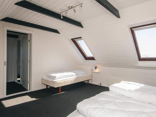 a attic room with two beds and a window at 5 person holiday home in Snedsted in Snedsted