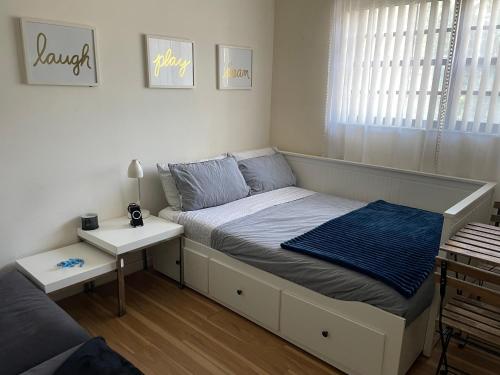 a small bedroom with a bed and a night stand at Beautiful suite in the best location in Miami! in Miami