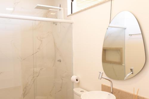 a bathroom with a shower and a mirror at ALDRAVA POUSADA BOUTIQUE in Tiradentes