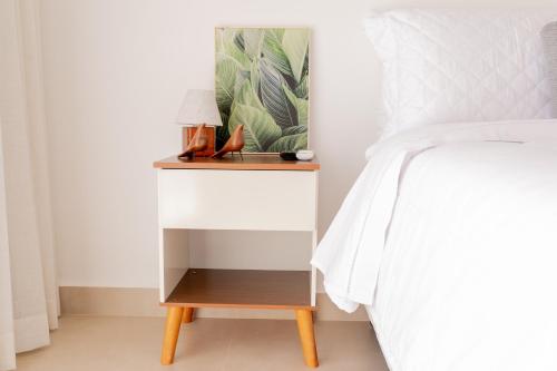 a bedside table with a night stand next to a bed at ALDRAVA POUSADA BOUTIQUE in Tiradentes