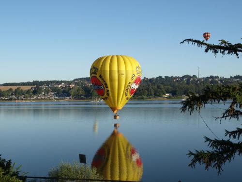 a yellow hot air balloon flying over a body of water at Forsthaus am Möhnesee in Möhnesee