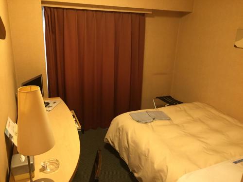 Ένα ή περισσότερα κρεβάτια σε δωμάτιο στο Hotel Crown Hills Kushiro