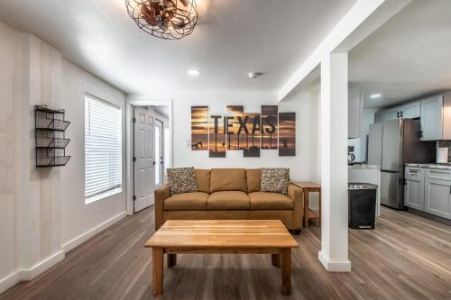 a living room with a couch and a table at Serenity Suites C in Corpus Christi