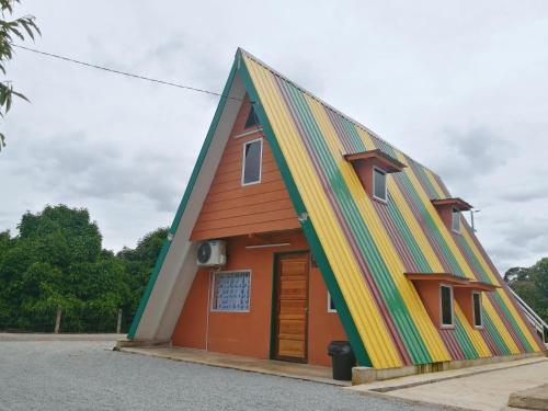a house with a colorful roof at Chemara Dusuntara Homestay in Jeniang