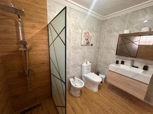 a bathroom with a toilet and a sink at Villa Amarilis in Boca Chica