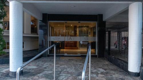 a building with a glass entrance to a store at Altair Hotel in San Clemente del Tuyú