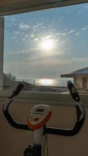 a view of the ocean from a window with a hair dryer at Altair Hotel in San Clemente del Tuyú