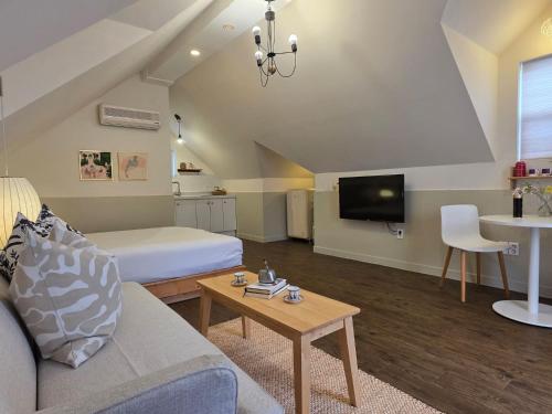a living room with a bed and a table at Adellia Pension in Gyeongju