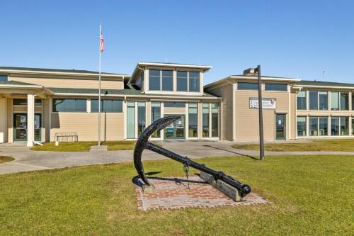 a statue in the grass in front of a building at Mi Faro Unit A Duplex in Harkers Island