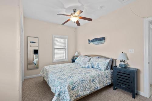 a bedroom with a bed and a ceiling fan at One More Drift home in Atlantic Beach