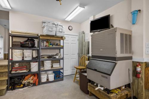 a garage with a room with a computer on a shelf at One More Drift home in Atlantic Beach