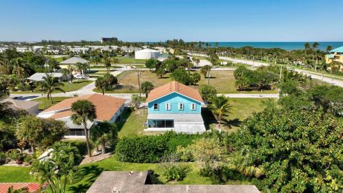 an aerial view of a house in front of the ocean at Seaside Serenity Cozy By The Sea in Fort Pierce