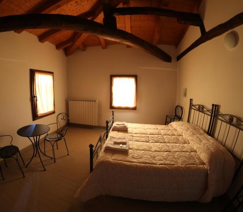 A bed or beds in a room at La Barchessa Country House