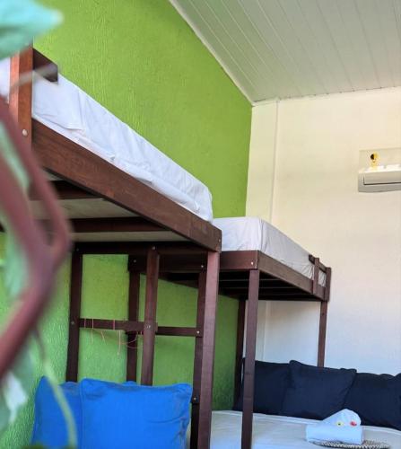 two bunk beds in a room with a couch at Pousada Cores do Pelô in Salvador