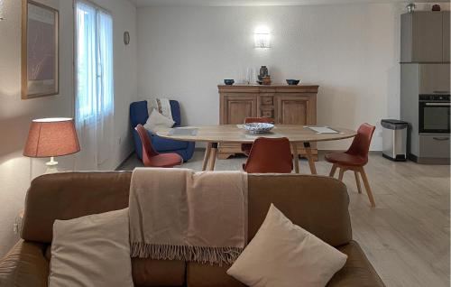 a living room with a couch and a table and chairs at Lovely Apartment In Algajola in Algajola