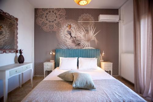 a bedroom with a bed with a blue headboard at Ionian Kaizer Boutique in Achílleion