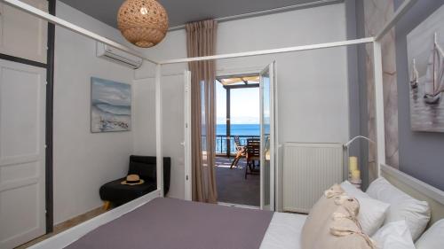 a bedroom with a bed and a view of the ocean at Ionian Kaizer Boutique in Achílleion
