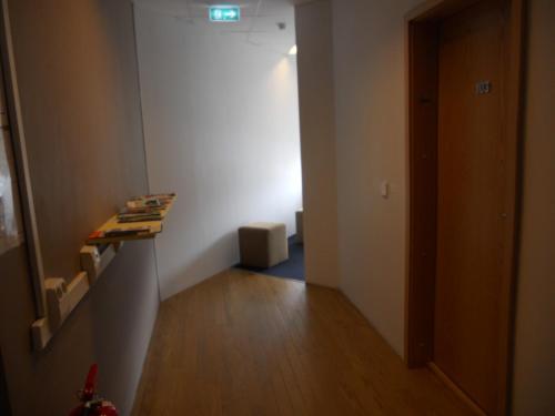 a room with a hallway with a door and a wooden floor at REK Inn in Reykjavík