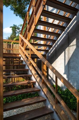 a wooden staircase leading up to a building at Ozone Cave in Thong Nai Pan Noi
