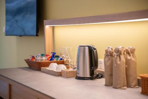 a counter top with a coffee maker and a mirror at Ozone Cave in Thong Nai Pan Noi