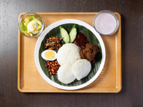 a plate of food on a tray with a bowl of food at APA Hotel Suidobashi Ekimae in Tokyo