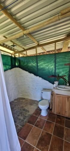 a bathroom with a toilet and a sink at El Cerrito in Puerto Jiménez