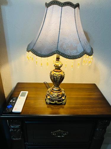 a lamp sitting on a table with a remote control at Hostería Casa Marquez in León