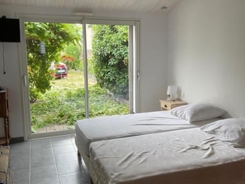 une chambre avec un lit et une grande fenêtre dans l'établissement Maison de Vacances à Noirmoutier - 4 Pers - Animaux Admis - FR-1-823-147, à Noirmoutier-en-l'lle