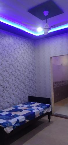 a bedroom with a bed with a purple ceiling at श्री कृष्णा होम स्टे in Vrindāvan