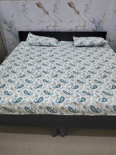 a bed with two pillows on top of it at श्री कृष्णा होम स्टे in Vrindāvan
