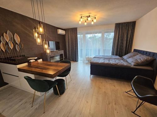 a bedroom with a bed and a table and chairs at Moderný 1 izbový apartmán v Ružinove in Bratislava