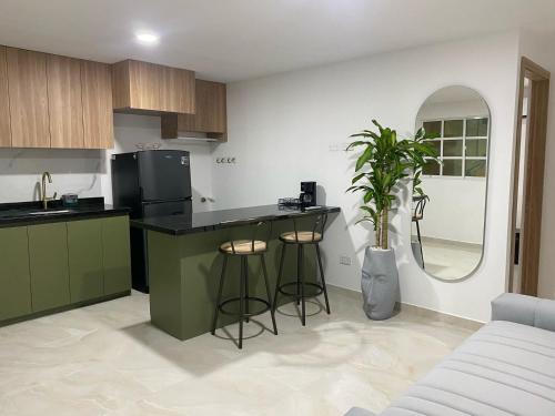 a kitchen with a counter and stools in a room at Apartamento Sabaii 201 in Cartagena de Indias