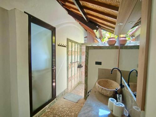 a bathroom with a large stone tub in a room at Solaluna Beach Homestay in Amed