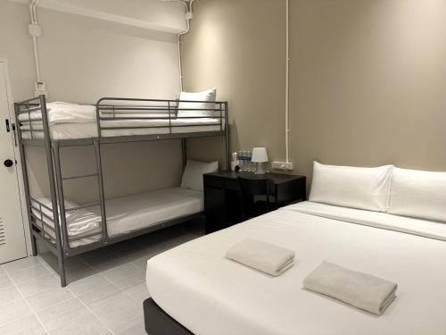 a room with two bunk beds and a bed at My House Guesthouse & Restaurant in Bangkok