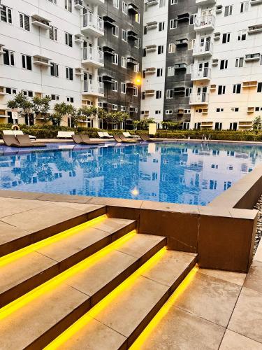 a large swimming pool in a large apartment building at The ARC Suites in Manila