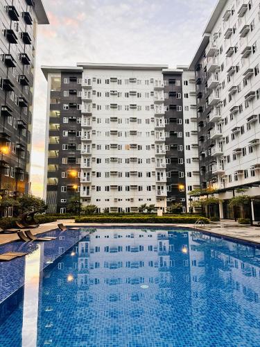 a large swimming pool in front of a large building at The ARC Suites in Manila