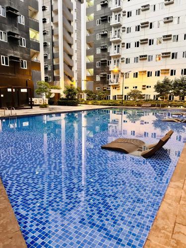 a large swimming pool in front of some buildings at The ARC Suites in Manila
