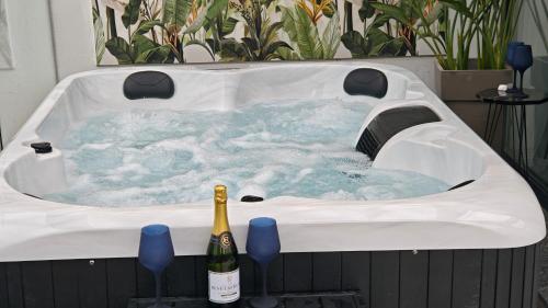 a hot tub with a bottle of wine in it at Muse by the beach with Jakuzzi in Amoudara Lasithiou