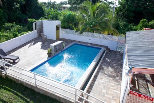 an overhead view of a swimming pool in a backyard at Lesville Tobago in Canaan