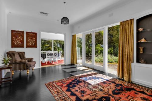 a living room with a bed and a chair at Dennarque Estate in Mount Wilson