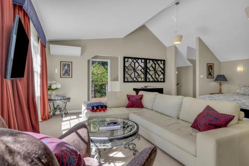 a living room with a white couch and a table at Dennarque Estate in Mount Wilson
