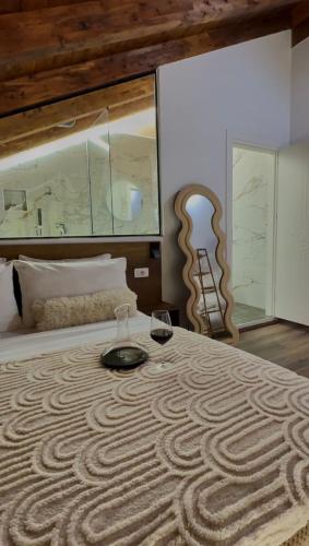 a bedroom with a large bed with a large painting at Guesthouse Marashi in Theth